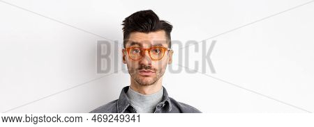 Attractive Brunette Man With Moustache, Wearing Stylish Glasses And Look Serious At Camera, No Emoti