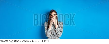 Cheerful Caucasina Girl In Dress Laughing And Having Fun, Covering Mouth With Hands And Chuckle Over