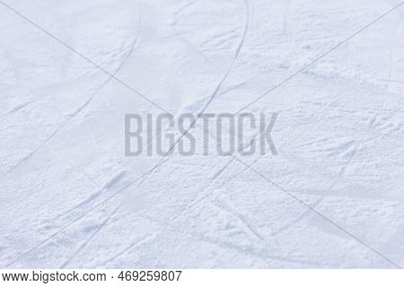 Ice Texture Close Up. Skating Rink Covered With Snow. Skate Tracks In The Snow