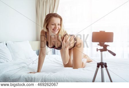 Young Sexy Woman Posing In Front Of Camera And Working As Webcam Model