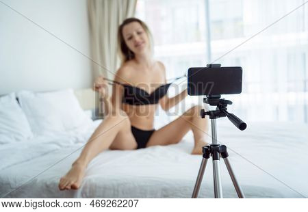 Young Sexy Woman Posing In Front Of Camera And Working As Webcam Model