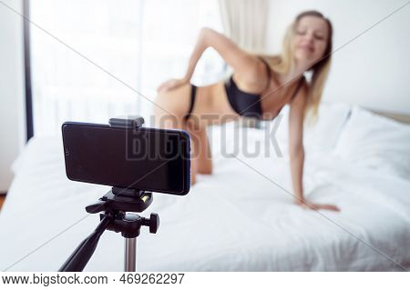 Young Sexy Woman Posing In Front Of Camera And Working As Webcam Model