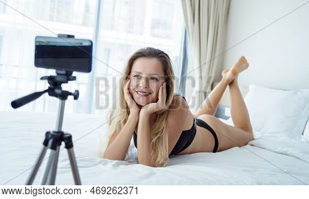 Young Sexy Woman Posing In Front Of Camera And Working As Webcam Model