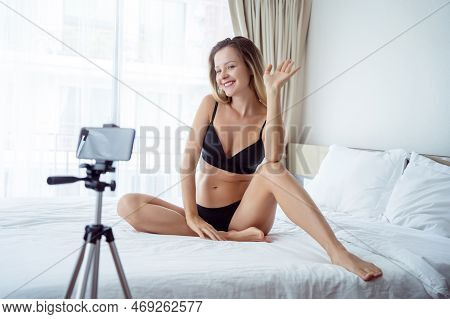 Young Sexy Woman Posing In Front Of Camera And Working As Webcam Model