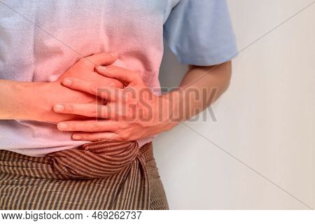 Asian Young Man Suffering From Upper Abdominal Pain. It Can Be Caused By Stomach Ache, Enteritis, Co