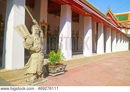 Cloister Of Wat Pho Temple With Chinese Guardian Statue, Historic Place In Bangkok, Thailand