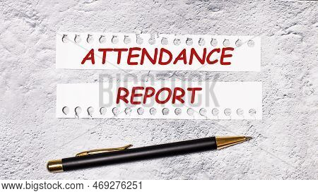 On A Marble Background Are Two Torn Strips Of White Paper With The Text Attendance Report And A Blac