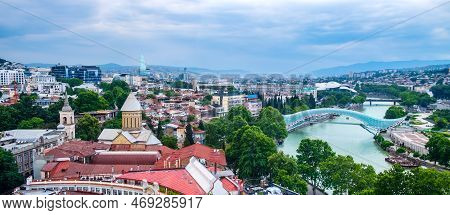 Panoramic View Over Old Town And Modern Architecture Of Tbilisi, Georgia. Cityscape With Mtkvari Or 