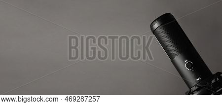Studio Condenser Microphone Isolated On Dark Background. Space For Text.