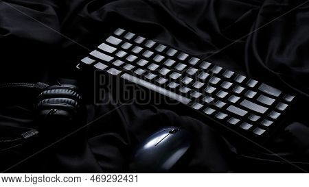 Trendy Gaming Computer Keyboard, Mouse And Audio Headphones In A Black Silk Interior. Wireless Techn