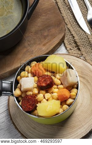 Cooked (cocido, Guiso) Stew, Chickpeas With Chorizo, Bacon, Carrot And Potato In Green Saucepan, Bla