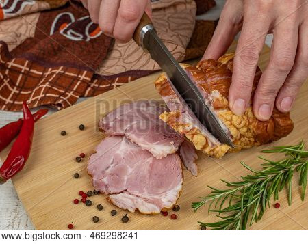 A Piece Of Juicy And Tasty Bacon Is Cut With A Kitchen Knife Into Appetizing Pieces. Close-up Of Fem