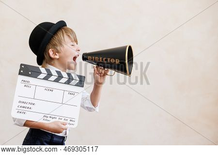 Newsboy Shouting Against Grunge Wall Background. Boy Selling Fake News