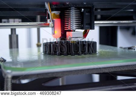 3d Printer Printing A Model Close-up. The Process Of Printing A Model On A 3d Printer Made Of Orange