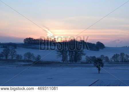 Orange Sunrise Above The Snow Covered Eifel Landscape