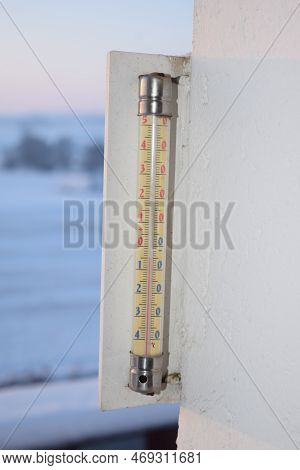 Thermometer Below Zero In Celsius Scale During A Snow Storm