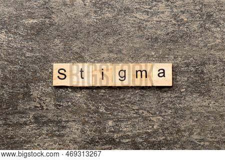 Stigma Word Written On Wood Block. Stigma Text On Table, Concept.