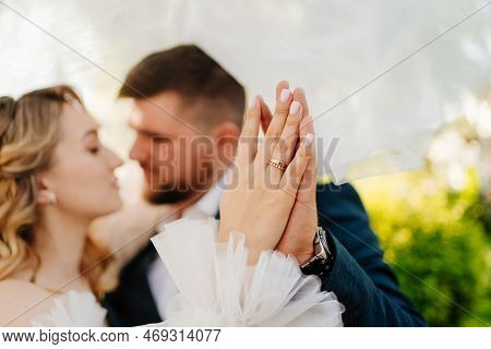 The Bride And Groom Hold Hands With Wedding Rings. Selective Focus.