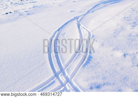 Bike Tracks In The Fresh Snow On A Road