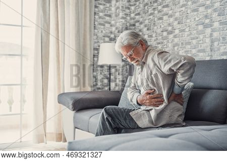Upset Senior Elder Man Feel Sudden Back Pain Muscles Ache Tension Injury Sitting At Home, Sad Old Gr