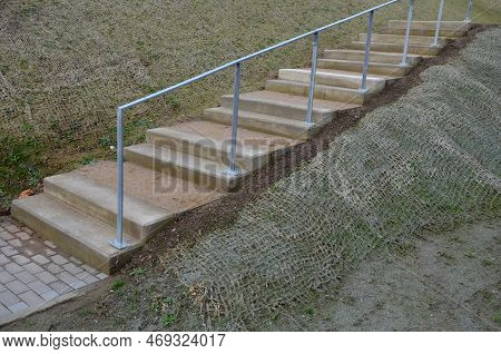 Outdoor Park Stairs On A Slope. Jute Mat Protects Against Erosion. Seed Spraying In A Cellulose Hydr