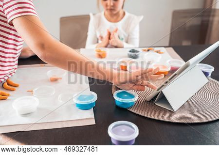 Little Girls Sculpt Figurines Crafts From Air Plasticine, Modeling Dough.online Lessons In Tablet. C
