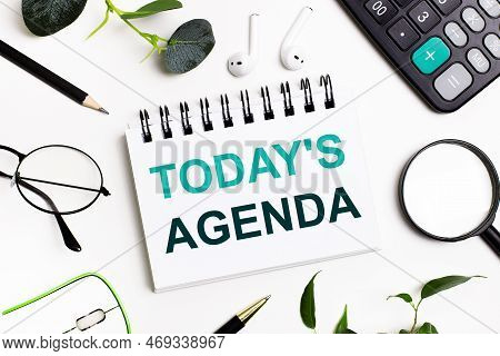 On A White Background There Are Business Accessories - A Calculator, A Pen, Glasses, A Magnifying Gl
