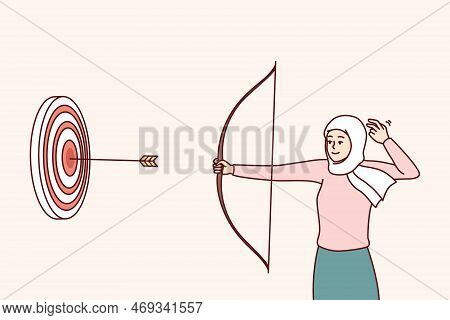 Woman In Islamic Headscarf Covering Hair Shoots At Target With Arrows Hitting Middle. Girl In Hijab 