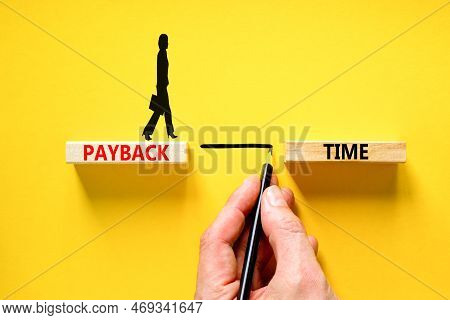 Payback Time Symbol. Concept Words Payback Time On Wooden Blocks. Beautiful Yellow Table Yellow Back