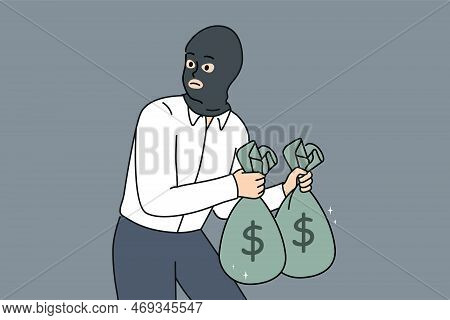 Male Thief In Face Mask Holding Bags With Money In Hands. Man Burglar Or Criminal Steal Cash From Ba
