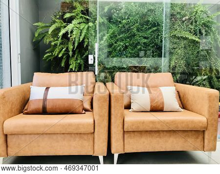 Interior Of Modern Living Room With Sofa, Armchair And Bookshelf