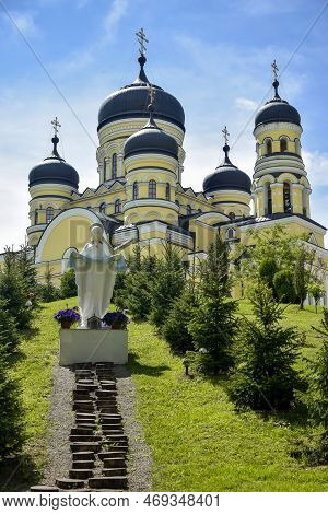 View Of Orthodox Cathedral With Domes In Monastery Against Background Of Green Landscape And Cloudy 