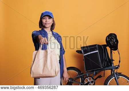 Pizzeria Delivery Worker Wearing Blue Uniform While Delivering Fast Food Order To Customer During Lu