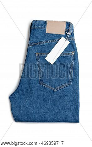 Blue Jeans Pants And Price Tag Isolated On White Background. Denim Background, Texture, Mockup. Fash