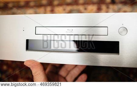 Paris, France - Oct 18, 2023: Pov Male Hand Holding New Onkyo Bd-sp809 Top-of-the-range Blu-ray Deck