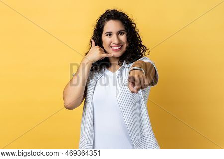 Hey You, Call Me Back, Lets Contact By Phone. Portrait Of Woman With Dark Wavy Hair Standing Pointin