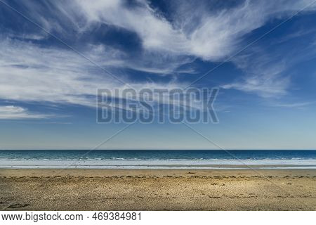 Landscape Of An Uncrowded Beach With White Clouds Over Blue Sky In Brittany, France.