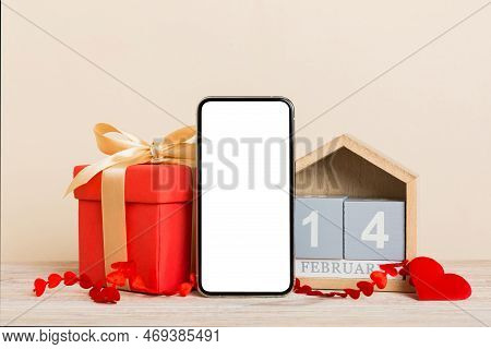 Mobile Phone With Blank Screen On Colored Background With Hearts, Calendar And Gift Box, Valentine D