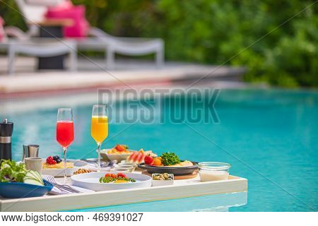 Breakfast in swimming pool floating. Luxury summer vacation or honeymoon destination. Resort hotel g
