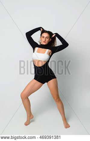 Photo Shoot Of A Beautiful Dancehall Dancer In The Studio On A White Background. Full Length Portrai