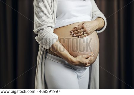 Pregnant Woman Putting On Anti-stretchmarks Creme On Her Belly.