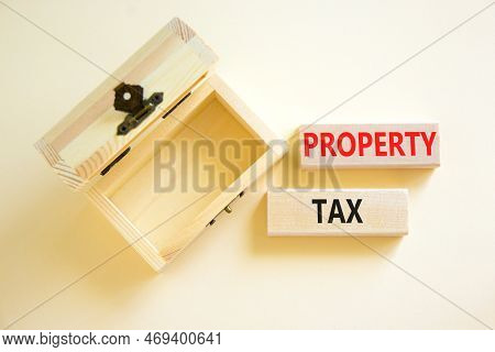 Property Tax Symbol. Concept Words Property Tax On Wooden Blocks. Beautiful White Table White Backgr