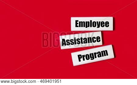 Three Wooden Blocks With The Text Eap Employee Assistance Program On A Bright Red Background. Copy S