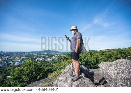 Asian Fat Man Stand On The Rock  Look At The Phone At Khao Hin Lek Fai View Point.khao Hin Lek Fai I