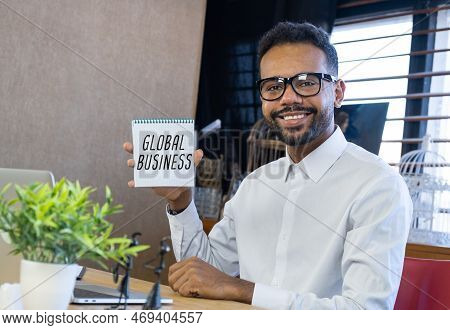 Smiling Feelancer With Notebook With Text Messaging Global Business At Home Office