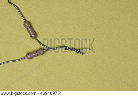 460k Ohm Resistors Wired In Series On A Yellow Background