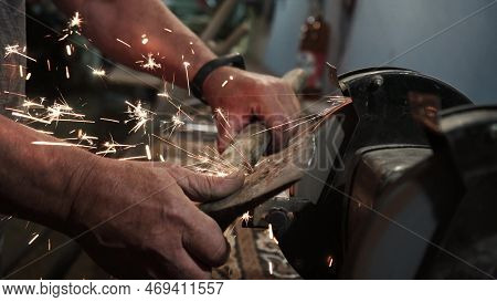Sharpening An Ax On An Electric Grinding Wheel, Machine Sharpening An Ax On An Electric Grinder, Han