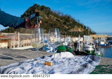 Pouring Of Txakoli Or Chacolí Slightly Sparkling Very Dry White Wine Produced In Spanish Basque Coun