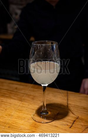 Pouring Of Txakoli Or Chacolí Slightly Sparkling Very Dry White Wine Produced In Spanish Basque Coun