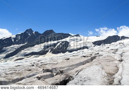 Mountain Grossglockner Panorama And Glacier Pasterze With Icefall Hufeisenbruch And Crevasses In Glo